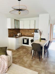 a kitchen and dining room with a table and chairs at T2 proche Thermes Vals Idéal curistes et familles in Vals-les-Bains