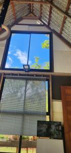 a window in a room with a view of a tree at Eco Bamboo House in Florianópolis