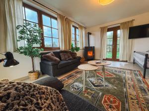 a living room with a couch and a table at Chalupa Lodge in Varvažov