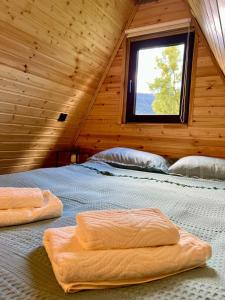 a bedroom with two beds in a wooden cabin at Mestia Sunrise Cottage, 1BR Mountain Stay Svaneti in Mestia