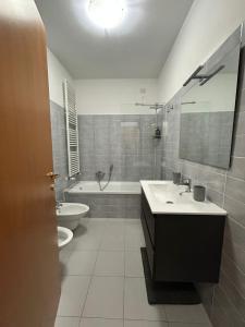 a bathroom with a sink and a tub and a toilet at Dreams Home in Locate di Triulzi
