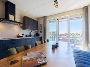 a kitchen and dining room with a table and chairs at Apartment in Sint-Annaland with Beach Access in Sint Annaland