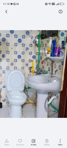 a bathroom with a toilet and a sink at Adem Cozy Home in Abu Dhabi +29 photos