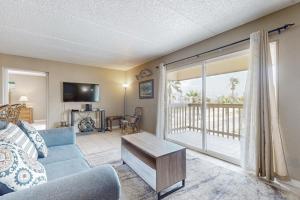 een woonkamer met een bank en een balkon bij Marlin Arms Condominiums #9 in South Padre Island