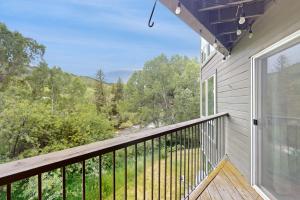 a balcony with a view of the woods at Bridgewater Sanctuary in Avon