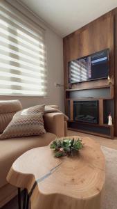 a living room with a couch and a coffee table at Jahorina Aspen 4 in Jahorina