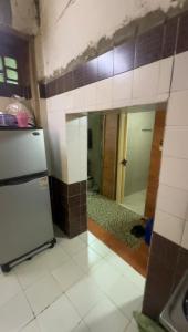 a kitchen with a refrigerator and a tile wall at Al Darb Al Ahmar in Cairo