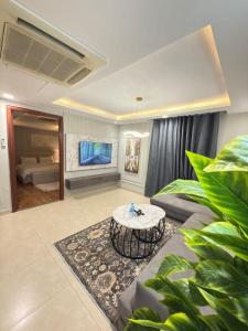 a living room with a couch and a table at Luxurious One-Bedroom Gold Crest Apartment with Stunning Balcony Retreat DHA Lahore in Lahore