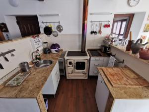 a kitchen with a sink and a stove at Mirador de Proacina - Senda del Oso  +18 photos