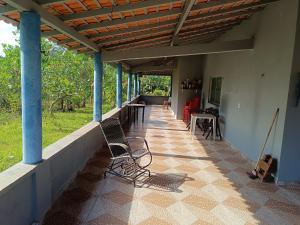 a porch of a house with chairs and a table at Paulo Sérgio Martins guerreiro in Benevides