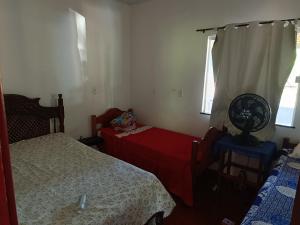a small bedroom with two beds and a table at Paulo Sérgio Martins guerreiro in Benevides