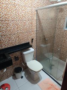 a bathroom with a toilet and a glass shower at Paulo Sérgio Martins guerreiro in Benevides