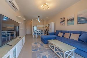 a living room with a blue couch and a table at Luxury Stays in Cyan El Gouna in Hurghada