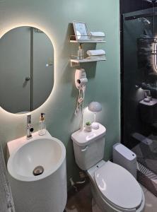 a bathroom with a sink and a toilet and a mirror at Eddys in Chihuahua