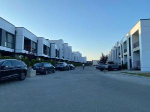 a parking lot with cars parked in front of buildings at Apartament Chișinău Arena in Chişinău