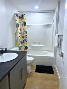 a bathroom with a sink and a toilet and a shower at Bliss Haven in Winnipeg
