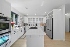 a kitchen with white cabinets and a white counter top at Book the Entire Eleanor Inn in Walla Walla