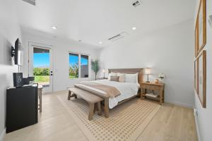 a bedroom with a large bed and a television at Sanitella Suite in Walla Walla