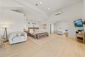 a large bedroom with a bed and a table at Eleanor Suite in Walla Walla