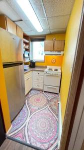 eine kleine Küche mit einem Teppich auf dem Boden in der Unterkunft Colorful Studio, near downtown, walk to shopping in Slaterville