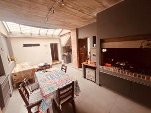 a dining room with a table and a fireplace at Casa Waikiki in Mar del Plata