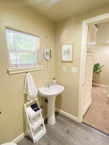 a bathroom with a white sink and a window at Near Downtown- Kitchen-washerdryer-parking in Medford