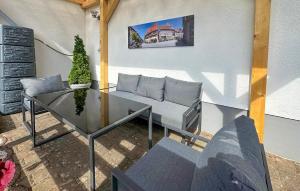 a patio with a couch and a glass table at Beautiful Apartment In Südharz With Wifi in Stolberg i. Harz +4 photos