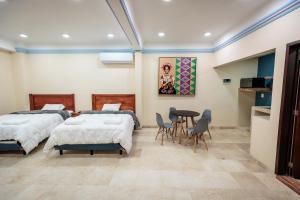 Postel nebo postele na pokoji v ubytování Casa Margarito Jalatlaco