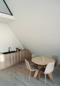 a dining room with a wooden table and chairs at A-FRAME Ξυλόκαστρο 