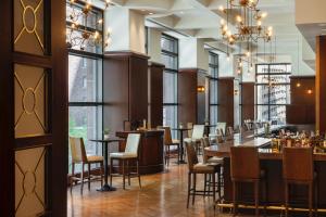 a restaurant with tables and chairs and windows at Omni Chicago Hotel in Chicago