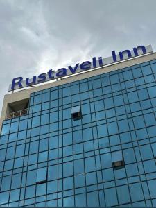 a sign on top of a building at Rustaveli Inn რუსთაველი ინნ in Rustavi