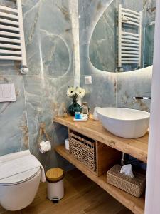 a bathroom with a sink and a toilet at Due Mari Suites - Fiera Milano & Portello in Milan