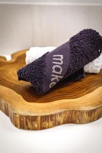 a wooden cutting board with two towels on it at Inspired Elegance at Tamarack Lodge in Canmore