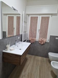 a bathroom with a sink and a toilet and a mirror at B&B Casa Tassoni in Maranello +10 photos