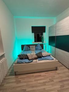 a bedroom with a large bed with blue walls at Wohnen inklusive Fitness & Wellness in Dessau