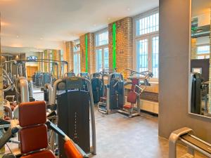 a gym with rows of treadmills and machines at Wohnen inklusive Fitness & Wellness in Dessau
