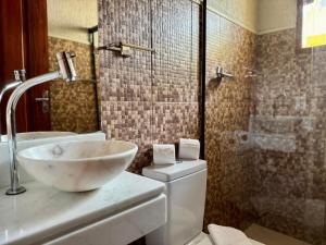 a bathroom with a sink and a toilet and a shower at Pousada Marcondes in Paraty +44 photos