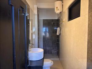 a bathroom with a toilet and a sink and a shower at Sood's Himalayan Vista in Kalimpong +44 photos