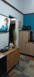 a living room with a tv with a picture of a person at Bungaillou in Lamentin +7 photos