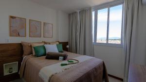 a bedroom with a large bed and a window at Novíssimo! Na 2ª quadra do mar! in Vila Velha +73 photos