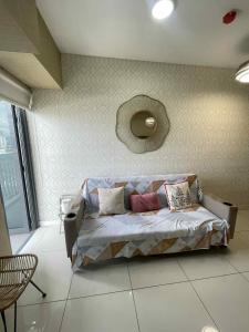a bedroom with a bed with pillows on it at Nica's Place in Cebu City