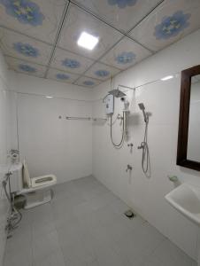a bathroom with a shower and a toilet and a sink at Zafara Resort in Udawalawe +16 photos