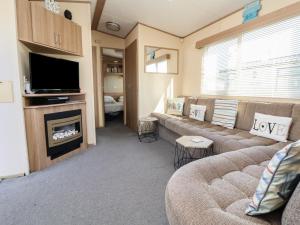 a living room with a couch and a fireplace at The Pad in Prestatyn