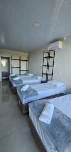 a group of four beds in a room at Casa do Vale in Ametista do Sul +12 photos