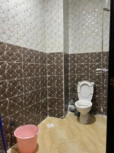 a bathroom with a toilet and a bucket at Mirleft Beach in Mirleft +55 photos