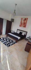 a bedroom with a bed with a zebra patterned rug at Les dunes in Sousse +9 photos