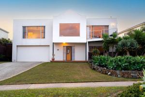 a white house with a driveway in front of it at Sweeping Ocean Views Pet Friendly in Torquay