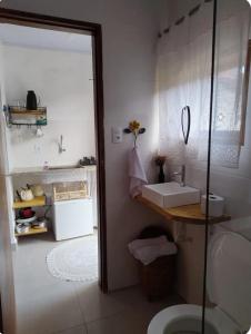 a bathroom with a sink and a toilet at Recanto da paz in Monte Verde
