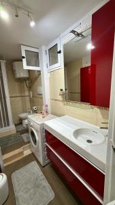 a bathroom with a sink and a washing machine at BELLO BORGO in Taranto +13 photos