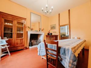a dining room with a table and a fireplace at Gîte cosy en Berry avec jardin et parking, proche de Châteauroux, pour 10 personnes - FR-1-591-31 in Arthon